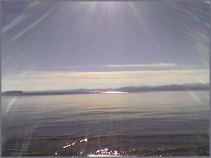 sunbeams shining on a calm lake